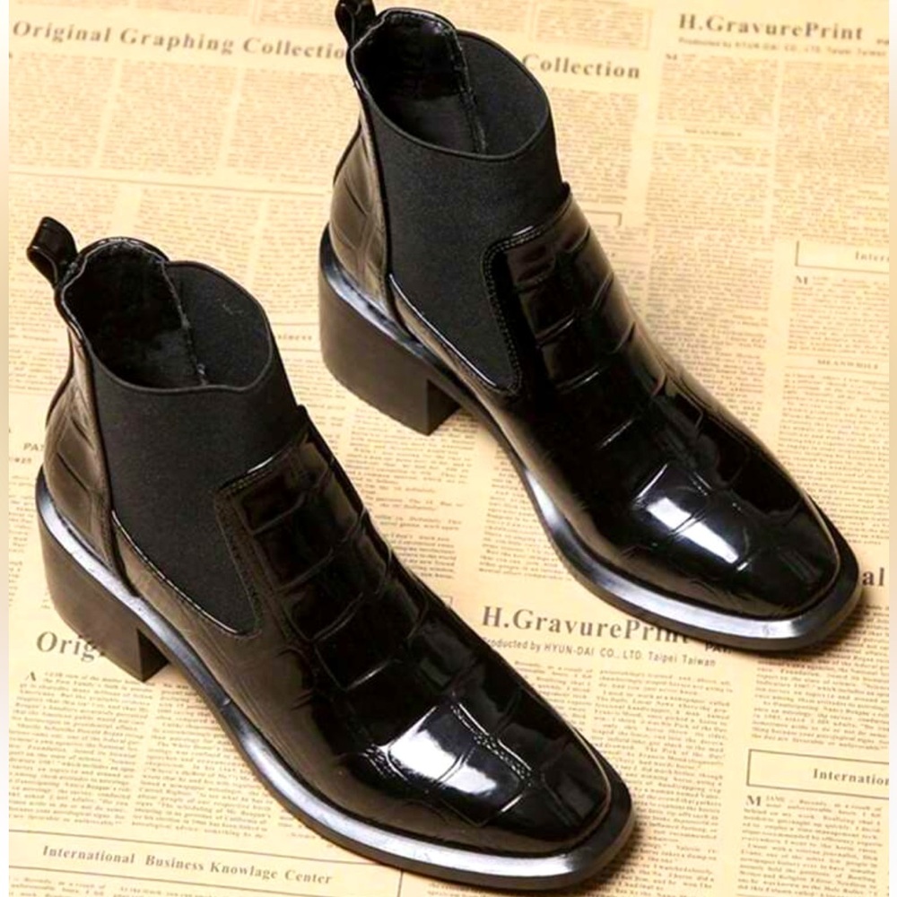 Black patent leather ankle boots.